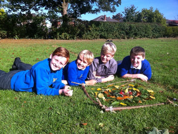 Pupils from Well Green Primary showing off their art work produced during sustainability week