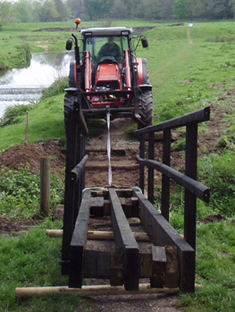 Footbridge being installed across stream at Wilmslow Park